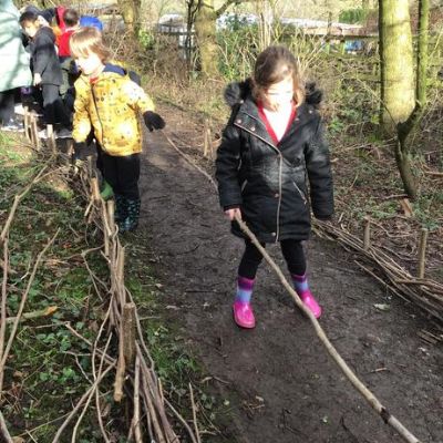 Elm class have been weaving outside today. We are trying to make a border for the path!