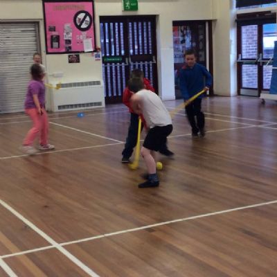 Having fun learning to play hockey.